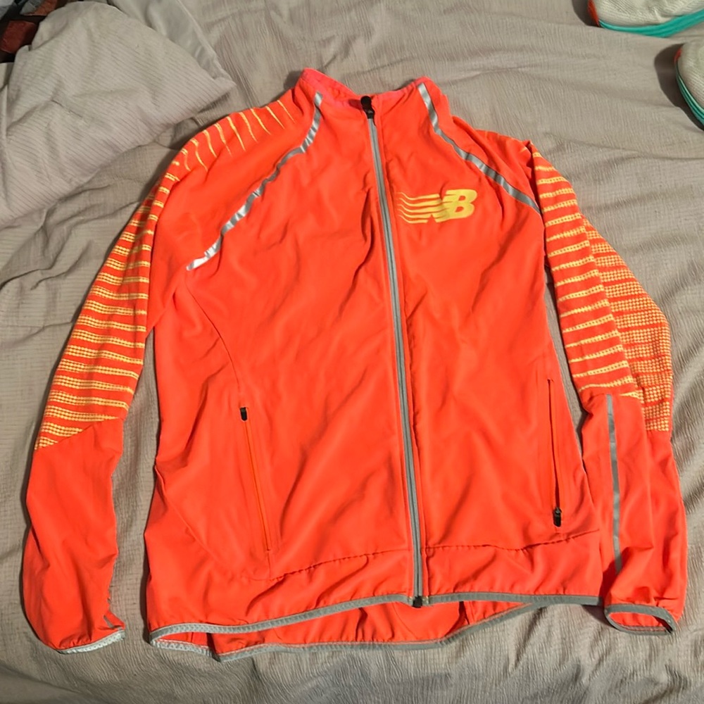 Women’s New Balance Beacon Jacket with glow in the dark details and reflective